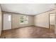 Bright living room featuring wood-look floors and ample natural light from large windows, creating a welcoming atmosphere at 141 Lakewind Dr, Mooresville, NC 28115