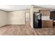 Spacious living room with wood-look floors and a black refrigerator, perfect for relaxing at 141 Lakewind Dr, Mooresville, NC 28115