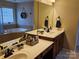 Bathroom featuring double sinks, white countertops, vanity, large mirrors and soaking tub at 14117 Hiawatha Ct, Huntersville, NC 28078