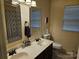 Double vanity bathroom with modern fixtures, large mirror, shower with patterned curtain at 14117 Hiawatha Ct, Huntersville, NC 28078