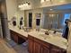 Bright bathroom featuring double sinks, white countertops, and vanity, plus separate glass enclosed shower at 14117 Hiawatha Ct, Huntersville, NC 28078