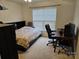 Bedroom featuring ceiling fan, dresser, desk, and bed with built-in bookcase at 14117 Hiawatha Ct, Huntersville, NC 28078