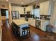 Spacious kitchen with an island, stainless steel appliances, white cabinets, and dark wood floors at 14117 Hiawatha Ct, Huntersville, NC 28078