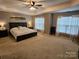 Spacious main bedroom featuring neutral walls, trey ceiling, ceiling fan, and large windows at 14117 Hiawatha Ct, Huntersville, NC 28078