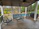 Covered patio featuring a ceiling fan, backyard view, and outdoor furniture overlooking the pool area at 14117 Hiawatha Ct, Huntersville, NC 28078