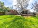 Expansive backyard featuring a well-maintained lawn, patio, and outdoor seating area at 1623 Geneva Ct, Charlotte, NC 28209