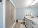 Modern bathroom featuring a marble countertop, vanity with storage, and a glass-enclosed shower at 1623 Geneva Ct, Charlotte, NC 28209