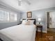 Bedroom with hardwood floors, a ceiling fan, and a comfortable bed with a white comforter at 1623 Geneva Ct, Charlotte, NC 28209