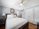 Bedroom with hardwood floors, a ceiling fan, and a comfortable bed with a white comforter at 1623 Geneva Ct, Charlotte, NC 28209