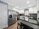 Modern kitchen with stainless steel appliances, granite counters and white cabinets and a large island at 1623 Geneva Ct, Charlotte, NC 28209