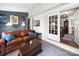 Inviting living room with blue accent wall, stylish decor and access to dining room through sliding doors at 1623 Geneva Ct, Charlotte, NC 28209