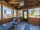 Inviting screened porch with comfortable seating, ceiling fan, and decorative cat tree at 1623 Geneva Ct, Charlotte, NC 28209