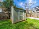 Green and white storage shed in the backyard for tools and equipment at 1623 Geneva Ct, Charlotte, NC 28209