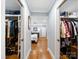 View of bedroom between two walk-in closets; organized shelves and hanging racks for ample storage space at 1623 Geneva Ct, Charlotte, NC 28209