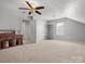 Large attic space with neutral carpet, window, and storage shelving at 2012 Oakstone Dr, Monroe, NC 28110