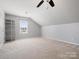 Spacious carpeted attic with a bright window, ideal for storage or a bonus room at 2012 Oakstone Dr, Monroe, NC 28110