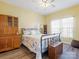 Comfortable bedroom with a ceiling fan and ample natural light from the window at 2012 Oakstone Dr, Monroe, NC 28110