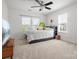 Bright bedroom featuring a ceiling fan, a large window, and neutral-colored carpet at 2012 Oakstone Dr, Monroe, NC 28110