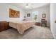 Bright bedroom featuring a ceiling fan, window, and neutral-colored carpet at 2012 Oakstone Dr, Monroe, NC 28110