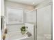 A bright bathroom featuring a shower with glass door, tub and window, plus white subway tiles at 205 Cowboys Cir, Rock Hill, SC 29732