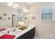 Elegant bathroom with double sinks, framed mirror, and decorative lamps at 205 Cowboys Cir, Rock Hill, SC 29732