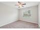 Empty bedroom with ceiling fan, neutral carpet, and a large window allowing natural light at 205 Cowboys Cir, Rock Hill, SC 29732