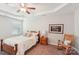 This bedroom features a ceiling fan, tray ceiling, rocking chair, and a window for natural lighting at 205 Cowboys Cir, Rock Hill, SC 29732