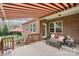 Inviting covered patio featuring brickwork, lounge seating, and awning, perfect for relaxing and outdoor enjoyment at 205 Cowboys Cir, Rock Hill, SC 29732