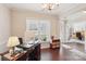 Bright home office with a large window, hardwood floors, and elegant trim details at 205 Cowboys Cir, Rock Hill, SC 29732