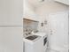 This laundry room features white cabinets and modern washer and dryer units at 205 Cowboys Cir, Rock Hill, SC 29732