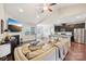 Open-concept living room and kitchen featuring hardwood floors, a fireplace, and modern appliances at 205 Cowboys Cir, Rock Hill, SC 29732