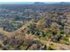 Scenic aerial view of a residential neighborhood with lush trees and mountain views in the distance at 210 W Lee Ave, Bessemer City, NC 28016