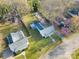 Aerial view of a charming home with a well-maintained yard, mature trees, and a detached structure at 210 W Lee Ave, Bessemer City, NC 28016