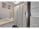 Functional bathroom with a tub/shower combination, a sink, and a washing machine and dryer unit at 210 W Lee Ave, Bessemer City, NC 28016