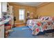 Bedroom with a vibrant comforter, a wooden desk, and plenty of storage space at 210 W Lee Ave, Bessemer City, NC 28016