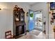 Inviting entryway with warm tones and an antique cabinet, leading to the front door at 210 W Lee Ave, Bessemer City, NC 28016