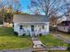 Charming single-story home with a quaint front porch, green lawn and mature shade trees at 210 W Lee Ave, Bessemer City, NC 28016