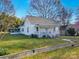 Charming single-story home with a quaint front porch, green lawn and mature shade trees at 210 W Lee Ave, Bessemer City, NC 28016