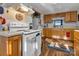 Functional kitchen featuring white appliances, wooden cabinets, and white subway tile backsplash at 210 W Lee Ave, Bessemer City, NC 28016