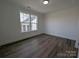 Bright bedroom with large window, hardwood floors, and white trim at 255 Luray Way # 442, Rock Hill, SC 29730