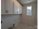 Bright laundry room with white cabinets, black hardware, and a window for natural light at 255 Luray Way # 442, Rock Hill, SC 29730