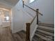 Elegant staircase with wooden banister and white risers, complemented by wood floors at 255 Luray Way # 442, Rock Hill, SC 29730