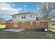 Two-story brick home featuring a well-maintained lawn, a sliding glass door, and a concrete patio at 2611 Rolling Hills Dr, Monroe, NC 28110