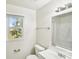 Bright bathroom featuring a vanity, a toilet, a window, and a shower/tub combo at 2611 Rolling Hills Dr, Monroe, NC 28110