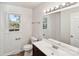 Bright bathroom featuring a vanity with dark wood cabinets, a toilet, a window, and a shower/tub combo at 2611 Rolling Hills Dr, Monroe, NC 28110