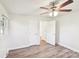 Neutral bedroom with ceiling fan, wood-look floors, and easy access to closet and other rooms at 2611 Rolling Hills Dr, Monroe, NC 28110