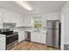 Updated kitchen featuring stainless steel appliances, white cabinetry, and a window over the sink at 2611 Rolling Hills Dr, Monroe, NC 28110