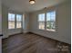 Sunny bedroom with hardwood floors and large windows offering a neighborhood view at 263 Luray Way # 444, Rock Hill, SC 29730