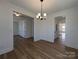 Open dining room with modern lighting, wood floors, and entrances to other rooms at 263 Luray Way # 444, Rock Hill, SC 29730