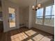 Bright dining area featuring hardwood floors, modern lighting, and an adjacent outdoor deck at 263 Luray Way # 444, Rock Hill, SC 29730